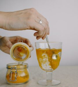 adding turmeric in glass of hot water